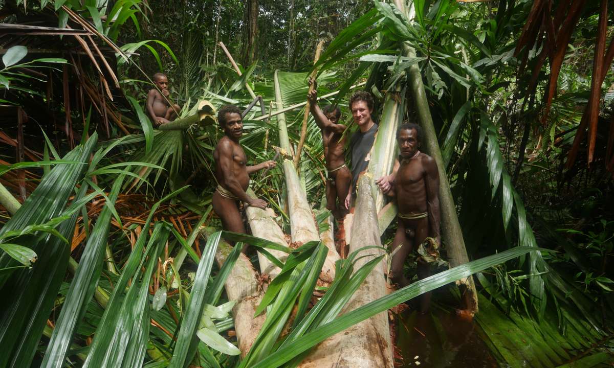Learning how to use natural resources and tools to construct parts of the village (BBC/ KEO Films)