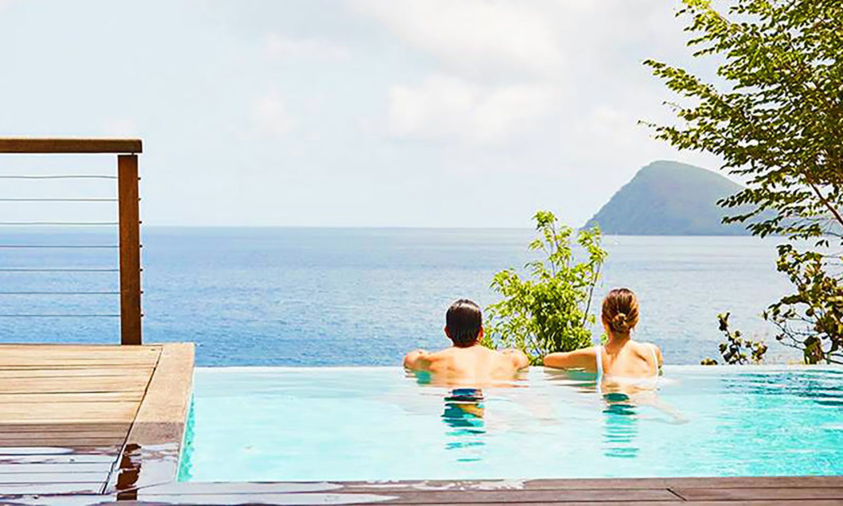 Relaxing in an infinity pool overlooking the ocean