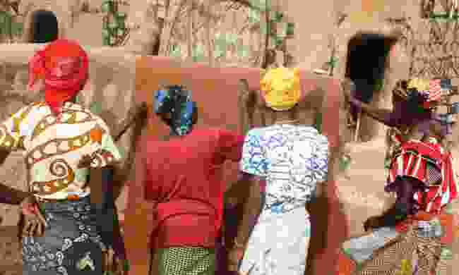 Women painting voodoo symbols in a Benin village (Shutterstock)