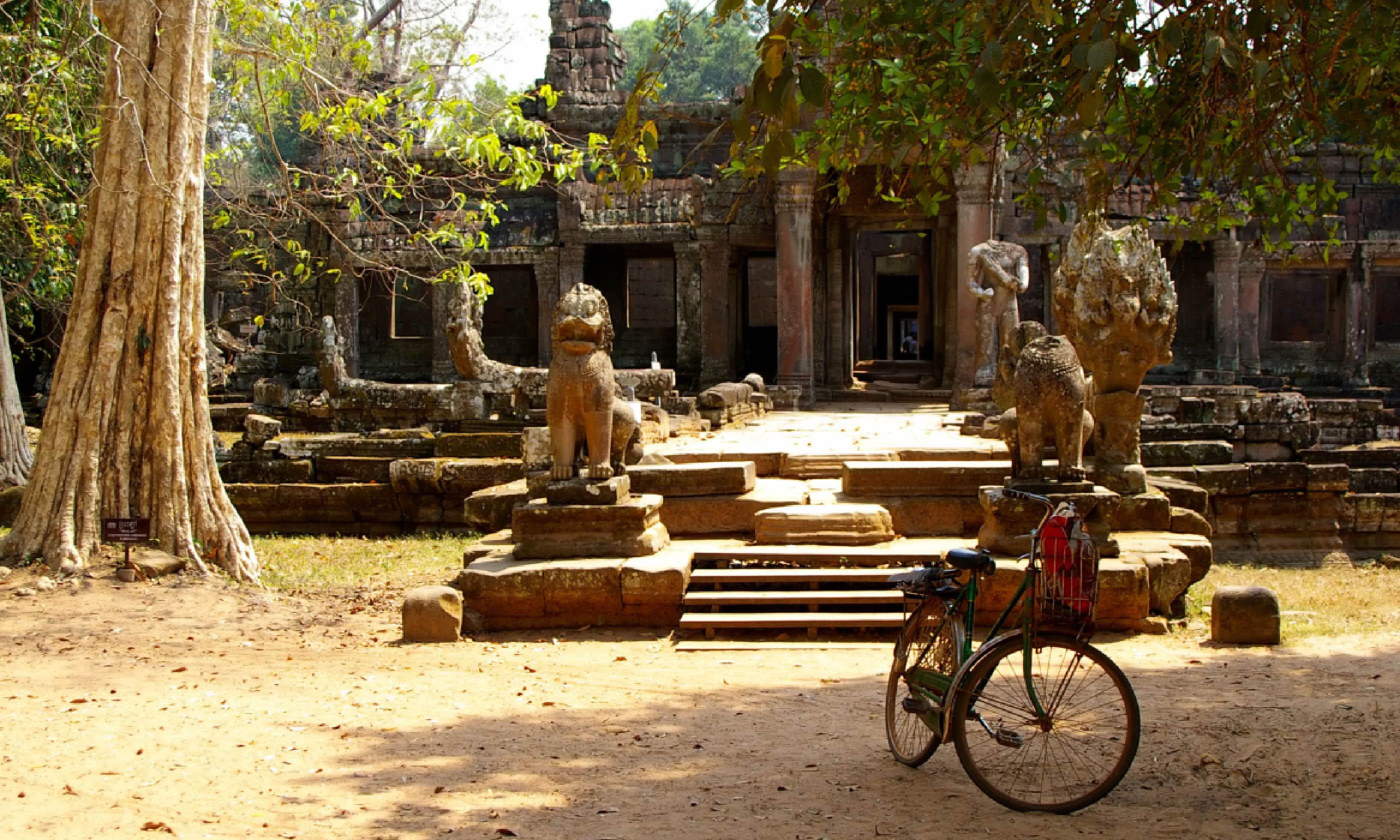Tour bike parked outside countryside Wat, Cambodia (Shutterstock)