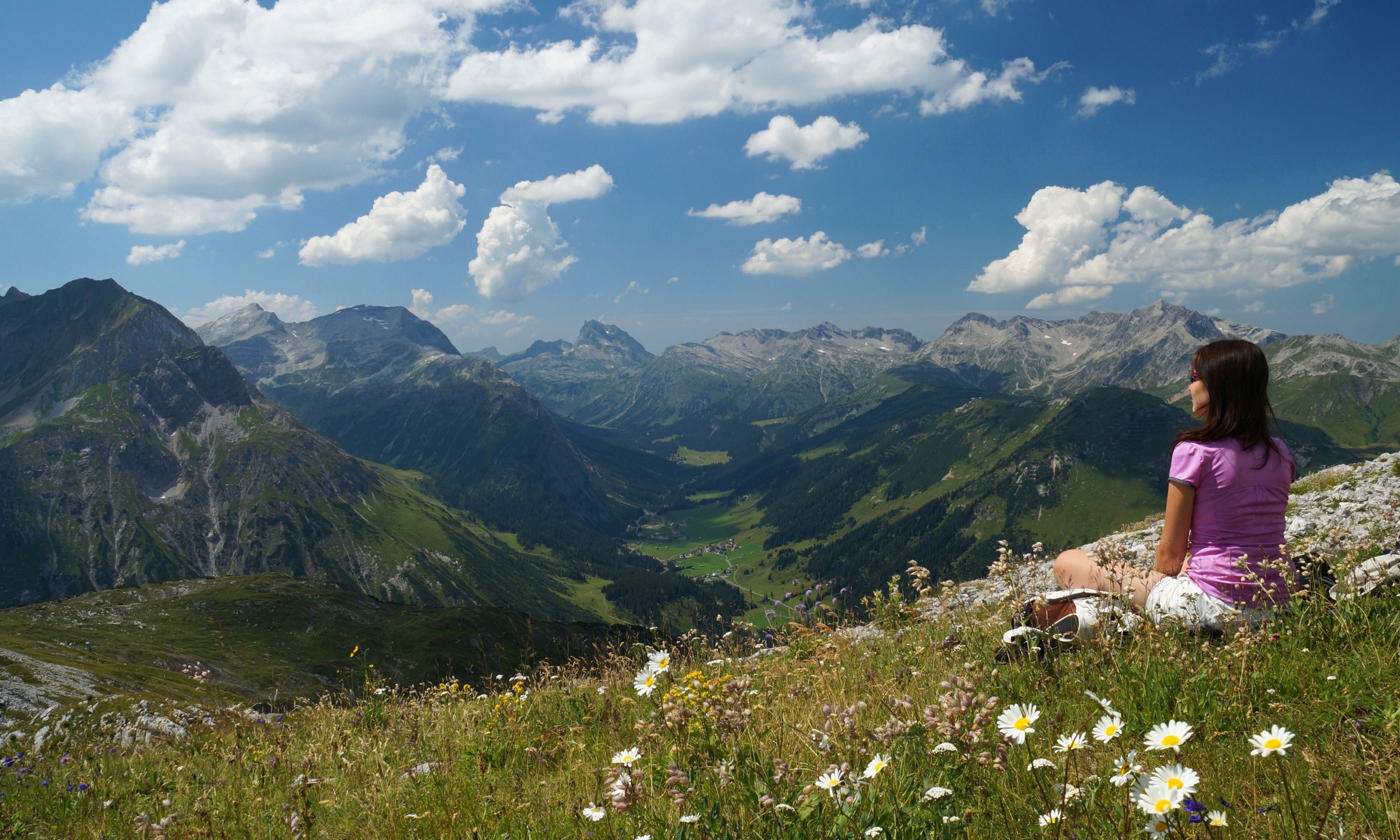 Woman resting in an Alpine meadow (Dreamstime)